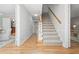 Hallway featuring hardwood floors, stairwell with wood trim, and access to other rooms at 3120 Beechwood Se Dr, Marietta, GA 30067