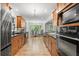 Modern kitchen with stainless steel appliances, wood cabinetry and a clear view to the breakfast nook at 3120 Beechwood Se Dr, Marietta, GA 30067