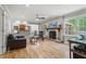 Cozy living room featuring a brick fireplace, hardwood flooring, and a view of the breakfast nook at 3120 Beechwood Se Dr, Marietta, GA 30067