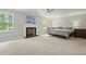 Large main bedroom with carpet, fireplace, two windows, and modern ceiling fan at 3120 Beechwood Se Dr, Marietta, GA 30067
