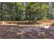 Spacious backyard is surrounded by a wooden fence and mature trees at 373 Hemlock Dr, Lawrenceville, GA 30046