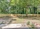 View of the backyard, featuring a new wooden fence and mature trees at 373 Hemlock Dr, Lawrenceville, GA 30046