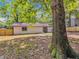 The home's private backyard features mature trees, a wood fence, and a flat grassy area at 373 Hemlock Dr, Lawrenceville, GA 30046