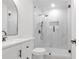 Stylish bathroom featuring modern vanity, toilet, and a frameless glass shower with marble-like walls at 373 Hemlock Dr, Lawrenceville, GA 30046