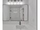 Modern bathroom featuring large vanity mirror, new fixtures, and white countertop at 373 Hemlock Dr, Lawrenceville, GA 30046