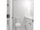 Bathroom featuring white cabinets, toilet, and new tile floor at 373 Hemlock Dr, Lawrenceville, GA 30046
