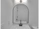 Modern bathroom featuring a sleek vanity with a frameless arched mirror at 373 Hemlock Dr, Lawrenceville, GA 30046