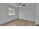 Bright bedroom features a modern ceiling fan and light hardwood floors at 373 Hemlock Dr, Lawrenceville, GA 30046