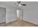 Bright bedroom features hardwood floors, a modern ceiling fan, and a closet with sliding doors for ample storage at 373 Hemlock Dr, Lawrenceville, GA 30046