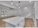 Modern kitchen featuring white cabinets, a large island, and stainless steel appliances, offering a contemporary design at 373 Hemlock Dr, Lawrenceville, GA 30046
