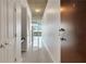 Hallway with hardwood door, white walls, a built in desk, and view of the city beyond the balcony at 855 Peachtree Ne St # 2912, Atlanta, GA 30308