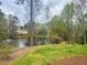 Serene backyard featuring a pond with a fountain, grassy area and an outdoor lounge setting at 1813 Baldwin Farms Dr, Marietta, GA 30068