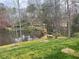 Backyard view with pond, trampoline, outdoor seating area and lawn at 1813 Baldwin Farms Dr, Marietta, GA 30068