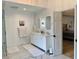 Bright bathroom with double vanity sinks, walk-in shower, marble floors, and an open door to the bedroom at 1813 Baldwin Farms Dr, Marietta, GA 30068