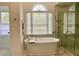 Bright bathroom with freestanding tub and walk-in shower featuring marble tile at 1813 Baldwin Farms Dr, Marietta, GA 30068