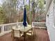 Outdoor deck area perfect for entertaining with table and seating for six with a wooded background at 1813 Baldwin Farms Dr, Marietta, GA 30068