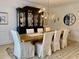 Elegant dining room featuring a large wooden table, upholstered chairs, and a display cabinet at 1813 Baldwin Farms Dr, Marietta, GA 30068