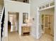Bright and airy foyer featuring hardwood floors, staircase, wainscoting, and views to other rooms at 1813 Baldwin Farms Dr, Marietta, GA 30068