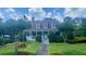 Charming two-story home with landscaped yard, American flag, and inviting front porch at 1813 Baldwin Farms Dr, Marietta, GA 30068