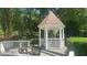 Inviting gazebo with seating, nestled in a serene, wooded area, perfect for relaxation at 1813 Baldwin Farms Dr, Marietta, GA 30068