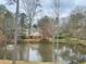 Beautiful pond featuring fountain, wooded surroundings and residential buildings on the opposite bank at 1813 Baldwin Farms Dr, Marietta, GA 30068
