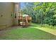 Backyard view of the home with a wooden deck and stairs leading to a well-maintained grassy area at 2316 Fripp Overlook Nw, Acworth, GA 30101