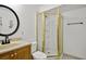 Bathroom featuring wood vanity, toilet, and shower stall with brass trim at 2316 Fripp Overlook Nw, Acworth, GA 30101