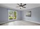 Bedroom featuring light walls, neutral carpet, large window offering natural light, and simple decor at 2316 Fripp Overlook Nw, Acworth, GA 30101