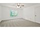 Bright bedroom featuring neutral carpet, ceiling fan, and a window with natural light at 2316 Fripp Overlook Nw, Acworth, GA 30101