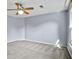Bedroom has light-blue painted walls, neutral carpet, and ceiling fan with light fixture at 2316 Fripp Overlook Nw, Acworth, GA 30101