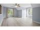 Spacious bedroom featuring hardwood floors, two windows, ceiling fan, and light-blue painted walls at 2316 Fripp Overlook Nw, Acworth, GA 30101