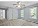 Bright bedroom has large windows, neutral carpet, and light-blue painted walls at 2316 Fripp Overlook Nw, Acworth, GA 30101