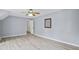 Bedroom features light-blue painted walls, ceiling fan, and light hardwood floors at 2316 Fripp Overlook Nw, Acworth, GA 30101