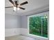 Bedroom featuring light-colored walls, a large window with a view, and a ceiling fan at 2316 Fripp Overlook Nw, Acworth, GA 30101