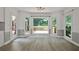 Bright dining area featuring hardwood floors, large windows, and access to a deck with outdoor seating at 2316 Fripp Overlook Nw, Acworth, GA 30101