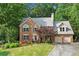 Charming brick home with a well-manicured lawn, mature trees, and a two-car garage at 2316 Fripp Overlook Nw, Acworth, GA 30101