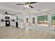 Open-concept kitchen and dining area featuring white cabinets, stainless steel appliances, and wood floors at 2316 Fripp Overlook Nw, Acworth, GA 30101