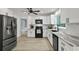 Modern kitchen featuring white cabinets, granite countertops, stainless steel appliances, and wood floors at 2316 Fripp Overlook Nw, Acworth, GA 30101