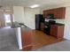 Efficient kitchen featuring black appliances, wooden cabinets, and a breakfast bar with a sink at 730 Georgetown Ln, Jonesboro, GA 30236