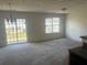 Bright living room with sliding glass doors and plenty of natural light from large windows at 730 Georgetown Ln, Jonesboro, GA 30236