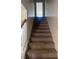 Carpeted staircase with wooden handrail leading to the upper level of the home at 730 Georgetown Ln, Jonesboro, GA 30236