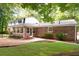 Backyard featuring red brick home, green grass, and plenty of foliage at 2179 Mountclaire Ct, Stone Mountain, GA 30087