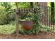 Rustic cauldron planter hanging on wood pergola in the backyard at 2179 Mountclaire Ct, Stone Mountain, GA 30087