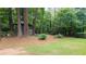 Lush backyard featuring a charming gazebo surrounded by mature trees and landscaping at 2179 Mountclaire Ct, Stone Mountain, GA 30087