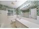 Bright bathroom featuring a marble countertop, patterned wall paper, and tiled floor at 2179 Mountclaire Ct, Stone Mountain, GA 30087