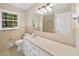 Neutral bathroom with vanity, ample lighting, and a shower with glass doors at 2179 Mountclaire Ct, Stone Mountain, GA 30087