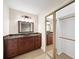 Bathroom with dark wood cabinets, decorative lighting and large mirrored closet at 2179 Mountclaire Ct, Stone Mountain, GA 30087
