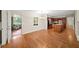 Open dining room with wood floors that flows into the kitchen and a sunroom at 2179 Mountclaire Ct, Stone Mountain, GA 30087