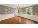 Bright dining room with hardwood floors and ornate wallpaper; great natural light at 2179 Mountclaire Ct, Stone Mountain, GA 30087