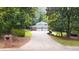 Charming exterior view of a house with an attached two-car garage surrounded by lush trees at 2179 Mountclaire Ct, Stone Mountain, GA 30087